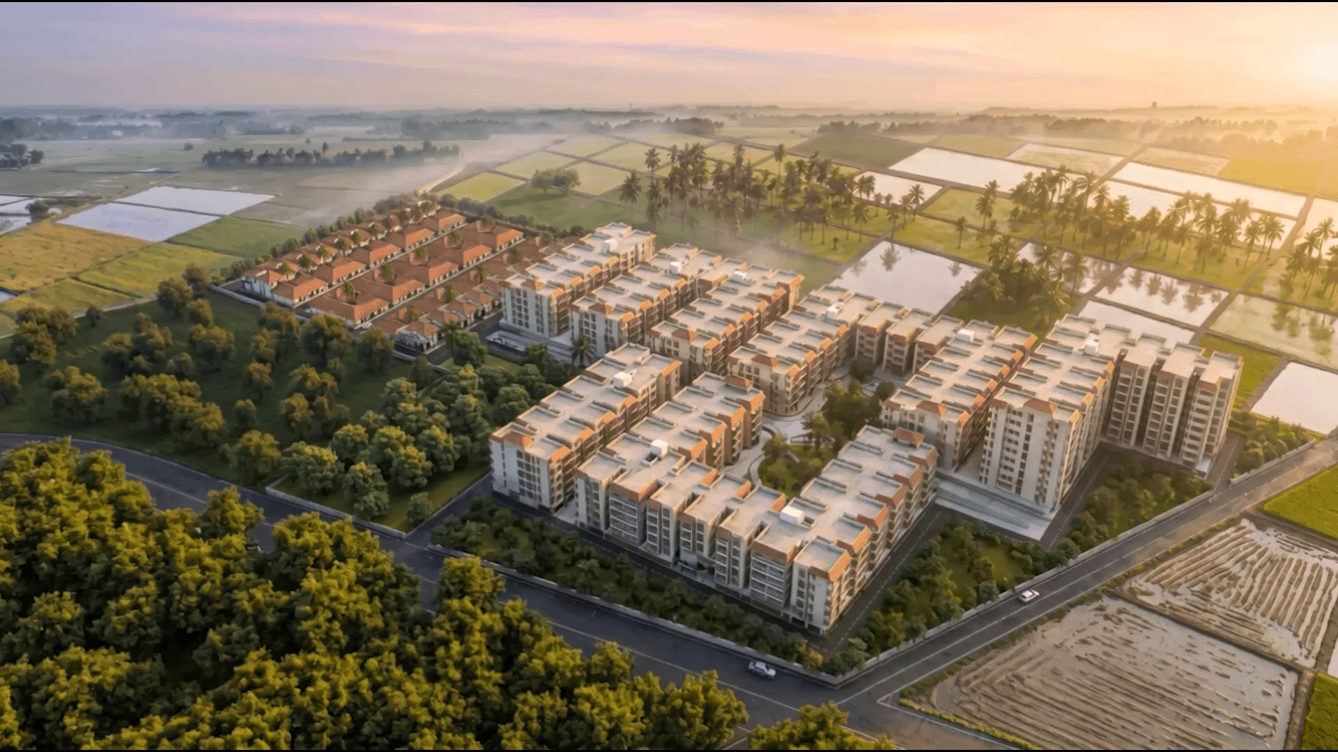 Aerial view of the Golden Planet senior heritage community at sunrise, surrounded by paddy fields near Mahabalipuram